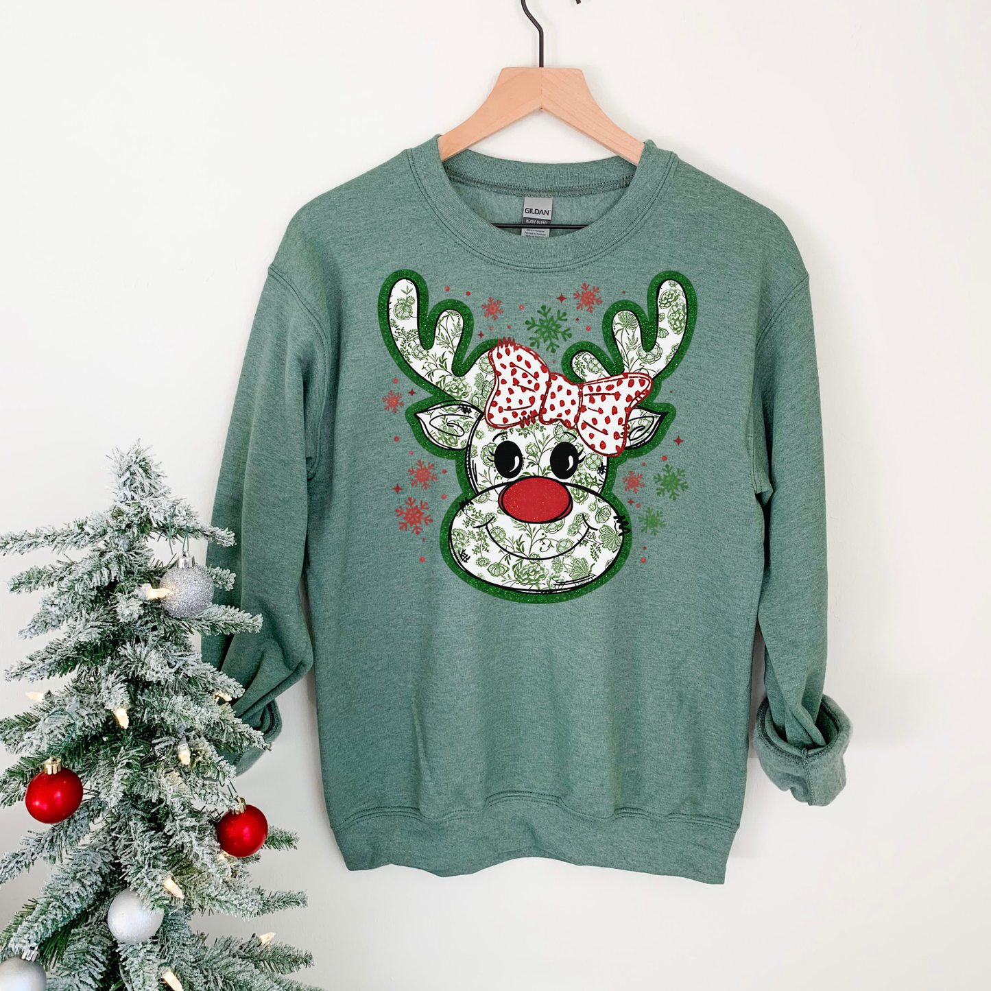 Reindeer with green and red bow